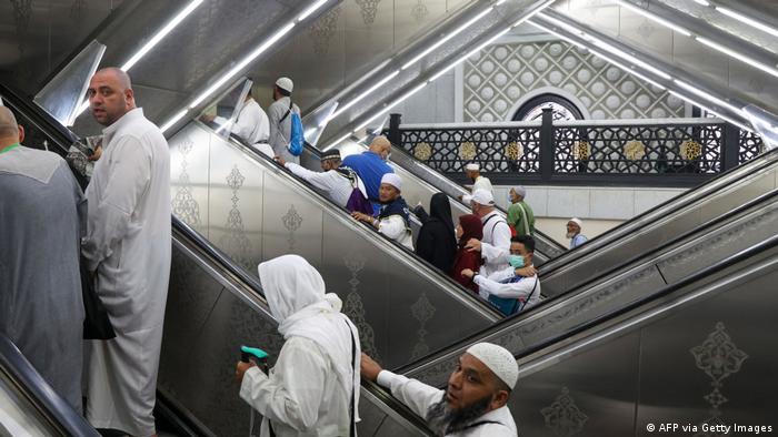 Muslim worshippers using escalators in the Grand Mosque in Saudi Arabia