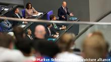 German Chancellor Olaf Scholz, center, answers to questions of lawmaker during a session of the parliament Bundestag in Berlin, Germany, Wednesday, July 6, 2022. (AP Photo/Markus Schreiber)
