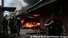 Firefighters work to control flames at the central market of Sloviansk on July 5, 2022, following a suspected missile attack amid the Russian invasion of Ukraine. (Photo by MIGUEL MEDINA / AFP) (Photo by MIGUEL MEDINA/AFP via Getty Images)