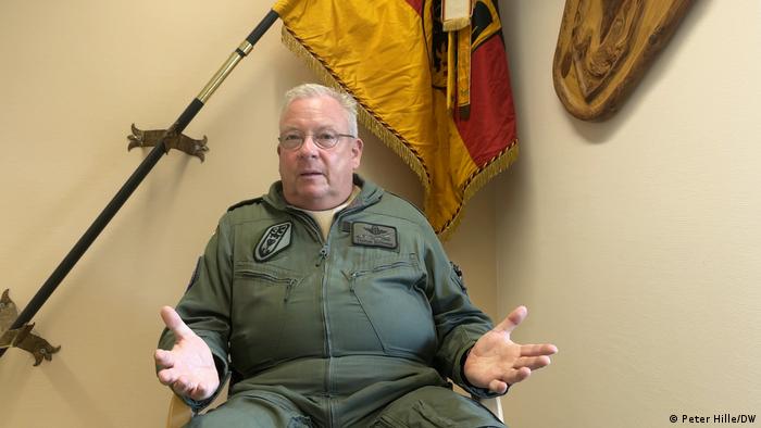 Thomas Schneider wears an Air Force jumpsuit