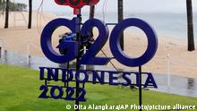 A police officer walks past a G20 sign in Nusa Dua, Bali, Indonesia, Thursday, July 7, 2022. Foreign ministers from the Group of 20 leading rich and developing nations are gathering in Indonesia's resort island of Bali for talks bound to be dominated by the conflict in Ukraine despite an agenda focused on global cooperation and food and energy security. (AP Photo/Dita Alangkara)