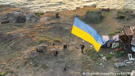 Ukrainian service members installed a national flag on Snake Island in the Black Sea
