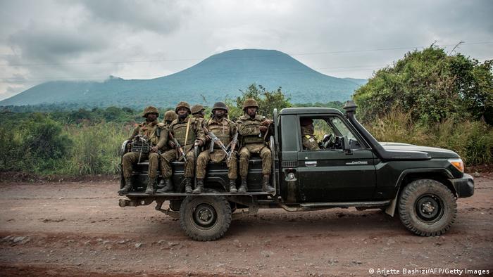 A Congolese army pick up carrying trooops heads towards the front line near Kibumba in the area surrounding the North Kivu city of Goma