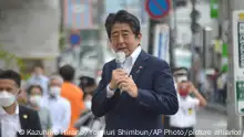 Japanese former Shinzo Abe speaks for his party member candidate of the House of Councillors election near Yamato Saidaiji Station in Nara Prefecture on July 8, 2022, just seconds before he is shot.   67-year-old Abe has reportedly been shot in the chest and he has been in a state of cardio-respiratory arrest. ( The Yomiuri Shimbun via AP Images )