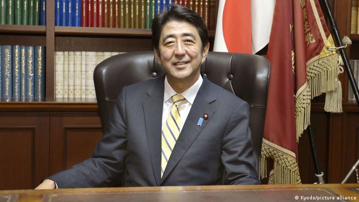 Shinzo Abe sitting in a chair