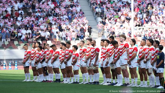 Japan's rugby players stand shoulder-to-shoulder on the field