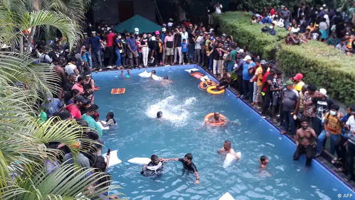Protesters demanding the resignation of Sri Lanka's President Gotabaya Rajapaksa swim in a pool inside the compound of Sri Lanka's Presidential Palace in Colombo