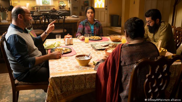 Still from 'Ms. Marvel': a family sharing a meal at a table.