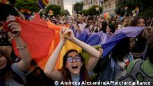 A girl screams holding a rainbow flag during the gay pride parade in Bucharest, Romania, Saturday, July 9, 2022. Thousands attended the gay pride march in the Romanian capital calling for legal rights for gays, like civil partnership, marriage or the right to adopt a child. (AP Photo/Andreea Alexandru)