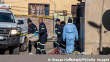 A team of from the forensic pathology service carry on a stretcher a victim's body towards their vehicle at a crime scene in Soweto, South Africa, on July 10, 2022. - Fourteen people were killed during a shootout in a bar in Soweto police said on July 10, 2022.
Police lieutenant Elias Mawela said that they were called in the early hours in the morning, around 12:30am after the shooting overnight Saturday and Sunday.
When police arrived at the scene, 12 people were confirmed dead.
11 others were taken to hospital with wounds but two later died, raising the death toll to 14. (Photo by Ihsaan HAFFEJEE / AFP) (Photo by IHSAAN HAFFEJEE/AFP via Getty Images)