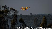 A firefighting plane takes part in wildfire fighting operations at Freixianda in Alvaiazere on July 10, 2022. - Around 1.500 firefighters were mobilized to put out three wildfires raging for more than 48 hours in central and northern Portugal, as the country was hit by a heat wave that prompted the government to declare a state of contingency. (Photo by PATRICIA DE MELO MOREIRA / AFP) (Photo by PATRICIA DE MELO MOREIRA/AFP via Getty Images)