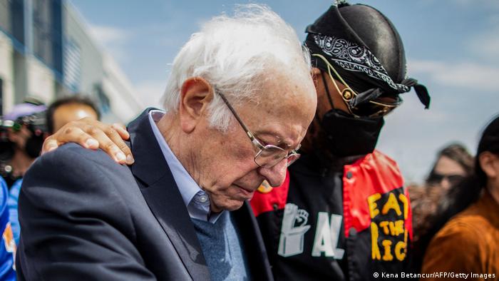 US Senator Bernie Sanders walks next to Amazon Labor Union leader Christian Smalls during a rally outside the company building in Staten Island, New York City
