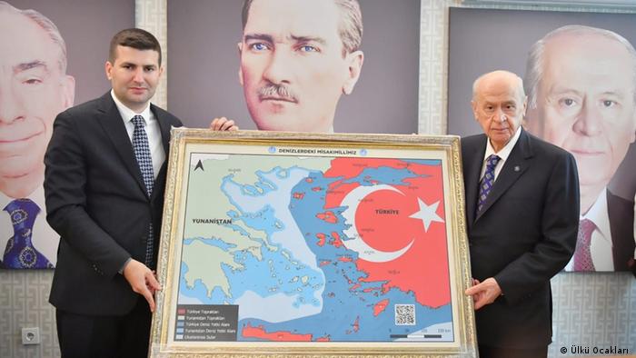 Turkish national Devlet Bahceli showing the map
