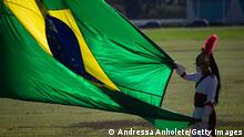 BRASILIA, BRAZIL - OCTOBER 27: A member of Dragon of Independence holds the flag before National Flag Raising amidst the coronavirus (COVID-19) pandemic at the Alvorada Palace on October 27, 2020 in Brasilia. Brazil has over 5.394,000 confirmed positive cases of Coronavirus and has over 157,134 deaths. (Photo by Andressa Anholete/Getty Images)