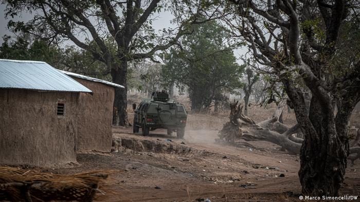 A Beninese military armored personnel carrier patrols the streets of Porga