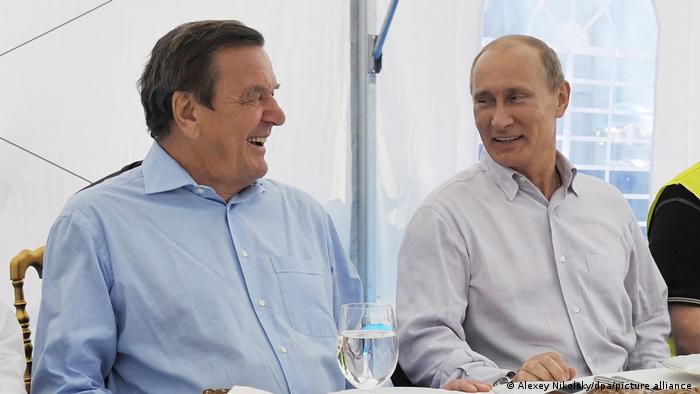 Archive image of Gerhard Schröder und Vladimir Putin chuckling, from 2011. 