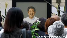 People gather to offer flowers at Zojoji Temple, where the funeral of late former Japanese Prime Minister Shinzo Abe, who was shot while campaigning for a parliamentary election, will be held, in Tokyo, Japan July 12, 2022. REUTERS/Kim Kyung-Hoon