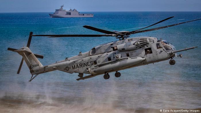 A United States ship and helicopter during routine military exercises with the Philippines in the South China Sea