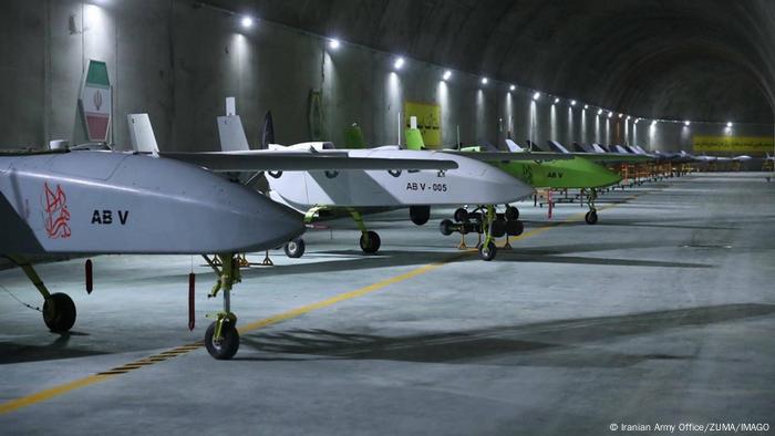 A line of drones in an underground bunker