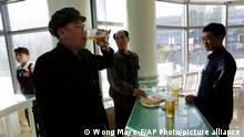 In this Saturday, May 7, 2016, photo, Pak Sun Won, 66, left, a retired physician drinks a glass of draft beer at the Taedonggang Beer shop with his friends in Pyongyang, North Korea. Ahead of the ongoing congress of North Korea's ruling Workers' Party, the nation was called upon to do massive overtime to boost production and show their devotion to leader Kim Jong Un in a 70-day loyalty campaign. And that's in addition to the hour after hour of rehearsals for huge rallies when their ruling party wraps up its first congress in decades. So how does a tired North Korean unwind? Beer. Beer. And more beer. (AP Photo/Wong Maye-E)