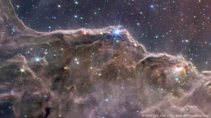 A picture of the edge of a young star-forming region called NGC 3324 in the Carina Nebula captured by the James Webb Space Telescope.