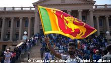 13.07.2022
A protester waves a national flag outside president Gotabaya Rajapaksa's office in Colombo, Sri Lanka, Wednesday, July 13, 2022. The president of Sri Lanka fled the country early Wednesday, slipping away in the middle of the night only hours before he was to step down amid a devastating economic crisis that has triggered severe shortages of food and fuel. (AP Photo/Eranga Jayawardena)