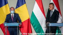 Hungarian Minister of Foreign Affairs and Trade Peter Szijjarto, right, and his Romanian counterpart Bogdan Aurescu hold a joint press conference at the Visitor Center of Almasy Castle in Gyula, Hungary, Wednesday, April 28, 2021. (Tibor Rosta/MTI via AP)