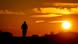 A man rides his bike on a small road in Frankfurt, Germany, as the sun rises A man rides his bike on a small road in Frankfurt, Germany, as the sun rises