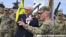 German President Frank-Walter Steinmeier and a soldier gesture in different directions as Steinmeier visits the Grafenwoehr U.S. Army training camp together with U.S. ambassador to Germany Amy Gutmann in Grafenwoehr, Germany, July, 13, 2022. REUTERS/Andreas Gebert