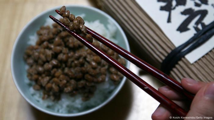 A bowl of rice and natto and chopsticks
