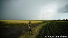 FILE - A Russian soldier guards an area next to a field of wheat as foreign journalists work in the Zaporizhzhia region in an area under Russian military control, southeastern Ukraine, Tuesday, June 14, 2022. Russian hostilities in Ukraine are preventing grain from leaving the “breadbasket of the world and making food more expensive across the globe, raising the specter of shortages, hunger and political instability in developing countries. This photo was taken during a trip organized by the Russian Ministry of Defense. (AP Photo, File)