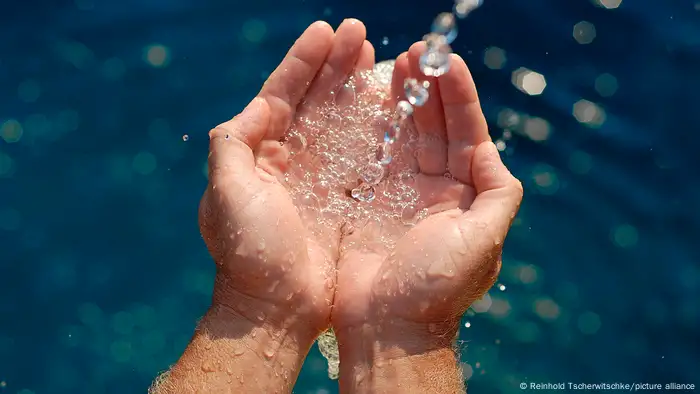 water flowing into cupped hands.