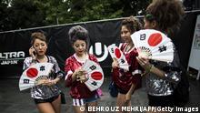 In this picture taken on September 19, 2016 Japanese women hold handfans bearing their national flag as they attend the Japan Ultra Music Festival at Odaiba Ultra Park in Tokyo.
A glittery haven for hardcore EDM junkies, Ultra's mega-rave has pitched up in 19 far-flung locations: including Argentina, Brazil and Chile in South America, and across the Atlantic in Spain and Croatia. Farther east, Ultra has extended its reach in Asia from Seoul to Tokyo, Taipei, Singapore, Bali, Bangkok and Hong Kong -- with organisers set to announce major additional expansion plans for 2017.
/ AFP / BEHROUZ MEHRI / TO GO WITH AFP STORY: Entertainment-Music-Festival / FOCUS by Alastair HIMMER
(Photo credit should read BEHROUZ MEHRI/AFP via Getty Images)
