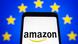 A photo illustration showing an Amazon logo on a smartphone screen with the EU flag in the background A photo illustration showing an Amazon logo on a smartphone screen with the EU flag in the background