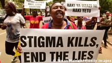 An activist holds up a placard reading 'Stigma kills, end the lies' during a demonstration outside the City County Assembly in Nairobi on April 24, 2019, to demand the removal of all advertisement with misleading information on the constitutional right to abortion. (Photo by Simon MAINA / AFP) (Photo credit should read SIMON MAINA/AFP via Getty Images)