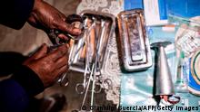 A woman practicing illegal abortion shows her working medical tools in her living room on July 25, 2019 in Antananarivo. - In Madagascar, the predominantly Christian island state where the Pope is expected in early September, abortion is illegal, including in cases of rape, and punishable by 10 years in prison. In this poor country of 25 million inhabitants, three women die each day following a spontaneous or induced abortion, according to Lalaina Razafinirinasoa, national leader of the British-based family planning NGO, Marie Stopes International. (Photo by GIANLUIGI GUERCIA / AFP) (Photo credit should read GIANLUIGI GUERCIA/AFP via Getty Images)
