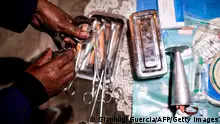 A woman practicing illegal abortion shows her working medical tools in her living room on July 25, 2019 in Antananarivo. - In Madagascar, the predominantly Christian island state where the Pope is expected in early September, abortion is illegal, including in cases of rape, and punishable by 10 years in prison. In this poor country of 25 million inhabitants, three women die each day following a spontaneous or induced abortion, according to Lalaina Razafinirinasoa, national leader of the British-based family planning NGO, Marie Stopes International. (Photo by GIANLUIGI GUERCIA / AFP) (Photo credit should read GIANLUIGI GUERCIA/AFP via Getty Images)