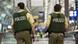 Two armed policemen in an airport Two armed policemen in an airport