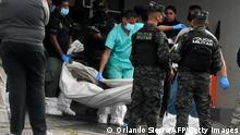EDITORS NOTE: Graphic content / Members of the Criminal Investigation and National Police move a corpse at the crime scene where Said Lobo Bonilla, son of former Honduran President (2010-2014) Porfirio Lobo Sosa, was murdered in Tegucigalpa on July 14, 2022. - A son of former Honduran President Pofirio Lobo was shot dead early Thursday morning along with three other people as they left a nightclub in Tegucigalpa, the former president and the authorities said. (Photo by Orlando SIERRA / AFP) (Photo by ORLANDO SIERRA/AFP via Getty Images)