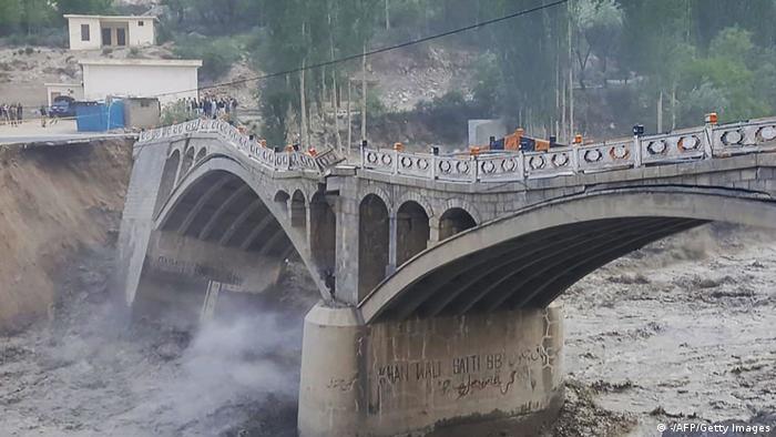 A bridge partially collapsed due to flash floods cretaed after a glacial lake outburst, in Hassanabad village, in Pakistan's northern Hunza district