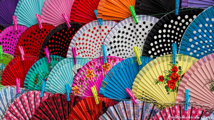 An array of colorful hand-held fans