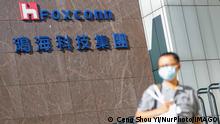 Taiwan-Foxconn-Hon Hai Group-Vaccines-COVID-19 A man with a face mask walks past the logo of Foxconn, or Hon Hai Group , which is Taiwans technology giant and the worlds leading producer of semiconductors or chips particularly for Apples devices, amid COVID-19 outbreak , in Taipei, Taiwan, 15 July 2021. Foxconn has together with TSMC helped Taiwan to buy BioNTech vaccines. Taipei Taiwan ceng-notitle210715_nprw7 PUBLICATIONxNOTxINxFRA Copyright: xCengxShouxYix