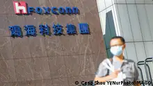 Taiwan-Foxconn-Hon Hai Group-Vaccines-COVID-19 A man with a face mask walks past the logo of Foxconn, or Hon Hai Group , which is Taiwans technology giant and the worlds leading producer of semiconductors or chips particularly for Apples devices, amid COVID-19 outbreak , in Taipei, Taiwan, 15 July 2021. Foxconn has together with TSMC helped Taiwan to buy BioNTech vaccines. Taipei Taiwan ceng-notitle210715_nprw7 PUBLICATIONxNOTxINxFRA Copyright: xCengxShouxYix