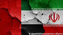 flags of UAE and Iran painted on cracked wall