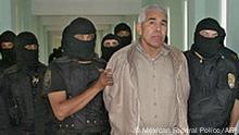 (FILES) In this file handout picture released by the Mexican Federal Preventive Police (PFP) on January 29, 2005, members of the PFP escort drug trafficker Rafael Caro Quintero, at the Puente Grande prion in Guadalajara, Jalisco State, Mexico. - Mexico has captured Rafael Caro Quintero, an alleged drug kingpin on the FBI list of 10 most wanted fugitives for the murder of a US federal agent, a navy source said on July 15, 2022. Rafael Caro Quintero is accused by the United States of ordering the kidnap, torture and murder of Drug Enforcement Administration (DEA) special agent Enrique Kiki Camarena in 1985. (Photo by Mexican Federal Police / AFP) / RESTRICTED TO EDITORIAL USE - MANDATORY CREDIT AFP PHOTO / MEXICAN FEDERAL PREVENTIVE POLICE - NO MARKETING - NO ADVERTISING CAMPAIGNS - DISTRIBUTED AS A SERVICE TO CLIENTS