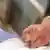 Hands clasped with person in hospital bed, drawing, partial graphic, euthanasia