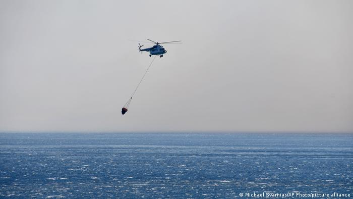 A helicopter flies over the sea off Samos