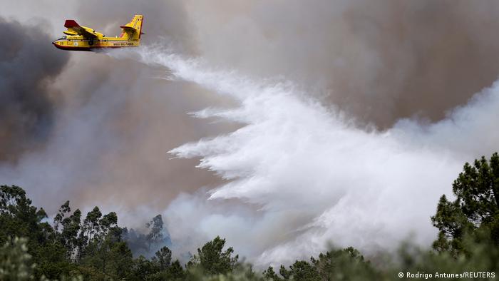 A fire fighting plane drops water in Portugal