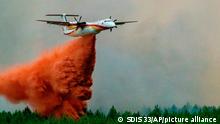 This photo provided by the fire brigade of the Gironde region (SDIS 33) shows a Dash aircraft fighting a wildfire near Landiras, southwestern France, Saturday July 16, 2022. Firefighters are struggling to contain wildfires in France and Spain as Europe wilts under an unusually extreme heat wave that authorities link to a rise in excess mortality. (SDIS 33 via AP)