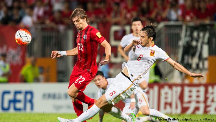 Hong Kong's Jaimes McKee (in red) battles China's Feng Xiaoting (in white) for the ball when the two teams met in November 2015.